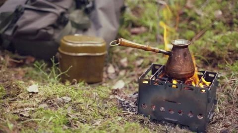 Preparing turkish coffee in a copper cezve over a fire. Boiling coffee cooking Видео 187735514