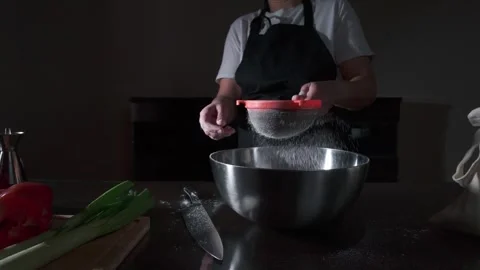 Preparing Vegan Lasagna: Sifting Flour for Homemade Pasta in a Rustic Kitchen Stock Footage 332771017
