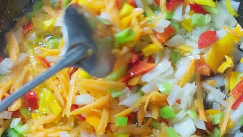 Preparing vegetable dish, frying vegetables in frying pan, stirring. Stock Footage 289087910