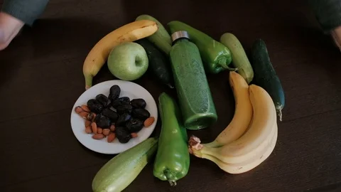 Preparing for vegetable green smoothie in the kitchen. Video stock 84938454