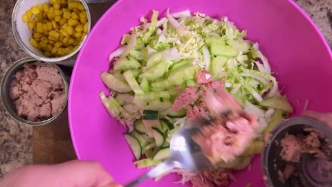 Preparing a vegetable salad with canned tuna, shrimp and napa cabbage leaves Stock-Footage 300454875