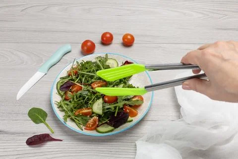 Preparing vegetable salad of tomatoes, cucumbers, greens. Stock Photos