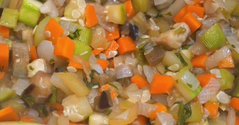 Preparing a vegetable stew. The cook stirs the vegetable ragout with a spoon Stock Footage 320733161