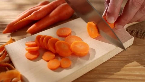 Preparing vegetables. cutting carrots on a cutting board. smooth camera zoom. Stock Footage 244444050