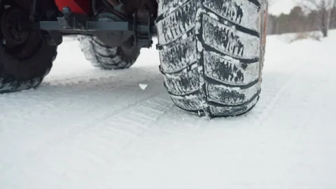 Preparing vehicle for winter trail. Closeup of tire and snowy terrain. Rider Stock Footage 345145683
