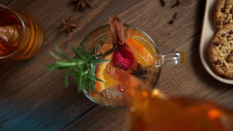 Preparing Warming Winter Tea with Orange, Cinnamon, Rosemary - Tabletop View Stock Footage 208932381