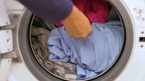 Preparing the wash cycle. Washing machine, hands and clothes Stock Footage 145721036