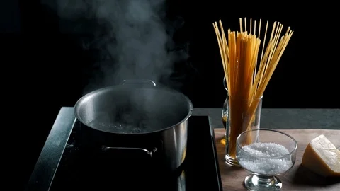 Preparing water for spaghetti in pan on electric stove in the kitchen Video stock 87272747