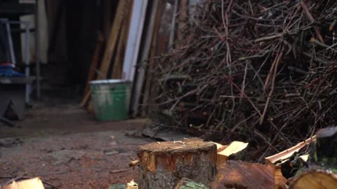 Preparing for winter chopping stumps for firewood to heat the house Stock Footage 327390042