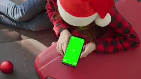 Preparing for the winter holidays with a smartphone in your hands. Planning a Stock Footage 257621442