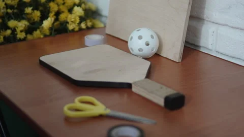 Preparing wooden pickleball racket for grip wrapping in carpentry workshop. Stock Footage 253281737
