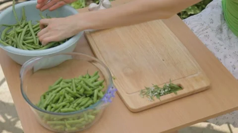 Preparing young green bunch of beans for slicing outdoors Stock Footage 8367231