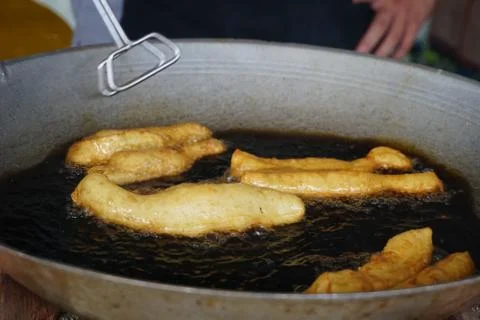 Prepation of Fried bread stick, Cakwe , the bread is also popularly known as  Stock Photos