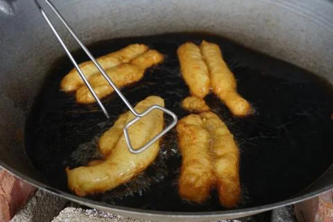 Prepation of Fried bread stick, Cakwe , the bread is also popularly known as  Stock Photos