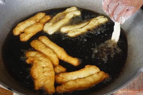 Prepation of Fried bread stick, Cakwe , the bread is also popularly known as  Stock Photos