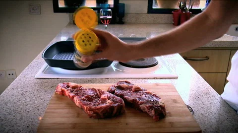 Prepering and Spicing Tasty Ready Steaks Stock Footage 732840
