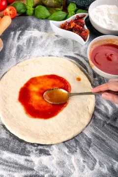 Prepering pizza dough for baking Stock Photos