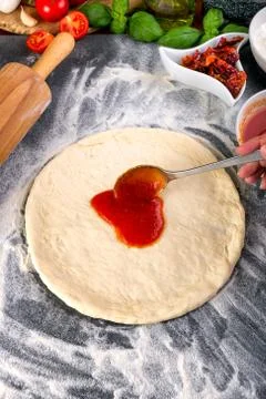 Prepering pizza dough for baking Stock Photos