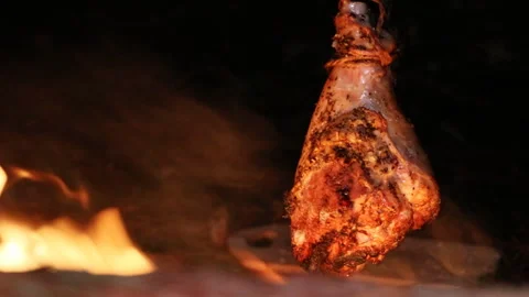 A prepper cooks food on an open fire. Stock Footage 208829963