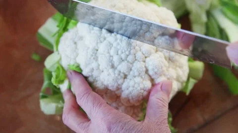 Prepping a fresh cauliflower closeup Stock Footage 102748230