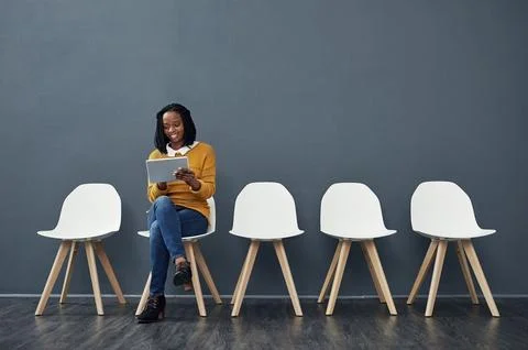 Prepping for her interview. Full length shot of an attractive young woman using Stock Photos