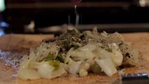 Prepping onions to eat in a kitchen Video stock 139015415