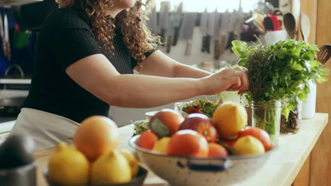 Prepping tomatoes on cutting board ingredients in a large kitchen with an array Stock Footage 199463678