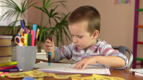 A preschool boy learns to write, draw with a pen in a notebook.He is preparing Stockbeeldmateriaal 162851436