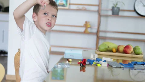 Preschool child constructing with cubes at living room. Video stock 273685978