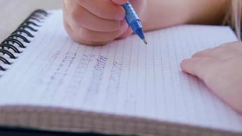 Preschool child draws elements with pen in lined notebook, Writing Before S.. Stock Footage 251889528
