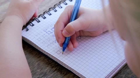 Preschool child draws elements with pen in lined notebook, Writing Before S.. Stock Footage 252571065