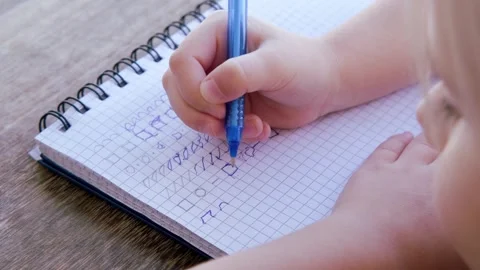 Preschool child draws elements with pen in lined notebook, Writing Before S.. Stock Footage 259242572