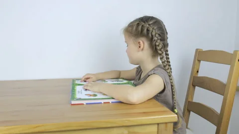 Preschool girl learning to read Stock Footage 101385563