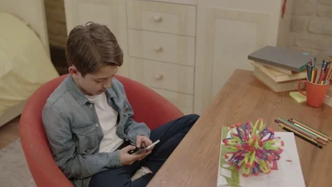 Preschool kid playing games, using mobile phone app. Video stock 198332635