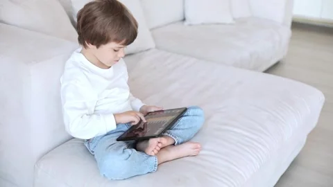 A preschool kid programmer coding at tablet pc, uses machine language Stock Footage 255741186