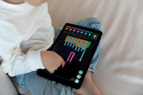 A preschool kid programmer coding at tablet pc, uses machine language Stock Photos