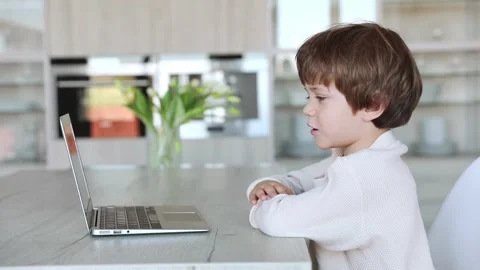 A preschool kid uses tablet pc Stock Footage 253975323