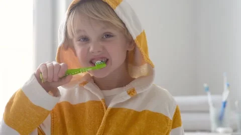 Preschooler boy is brushing his teeth with toothbrush carefully Stock Footage 148450724