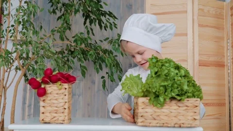 Preschooler with chief hat sorting and exploring the healthy food 库存影片 74561387