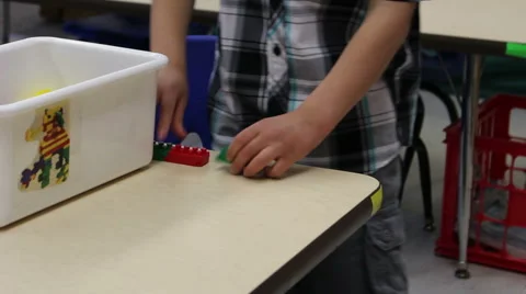 Preschooler creating a long chain using blocks Stock Footage 42873959