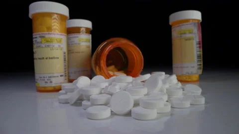 Presciption pills dumped in studio black background Stock Footage 137565626