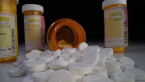 Presciption pills dumped on table Stock-Footage 137565616