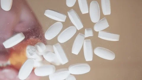 Prescription Pills Fall from a Bottle in Slow Motion Stock Footage