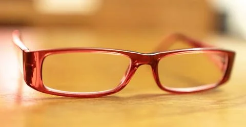 Prescription Red Rectangular Eyeglasses Purchased at Pharmacy on Wooden Surfa Фото