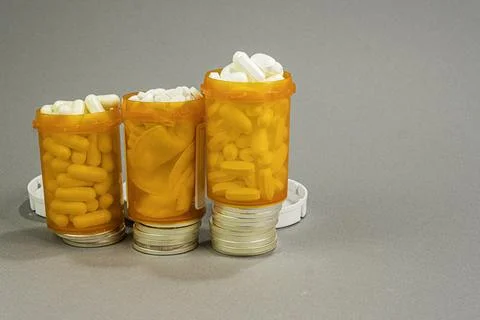 Prescripton bottles on Silver Dollars. Concept of expense. Stock-Fotos