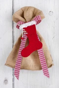 Present bag with santa boot on white background for christmas Stock Photos