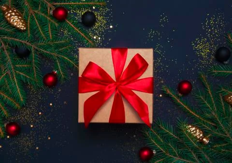 Present box with decorations on black background Stock Photos