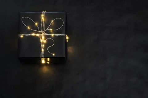 Present Box wrapped with string lights Stock Photos