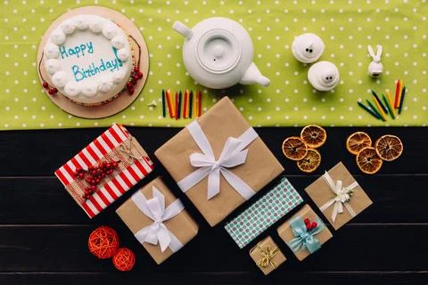 Present boxes and birthday cake Stock Photos