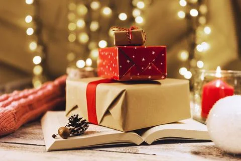 Present boxes book near burning candle . High quality and resolution beautiful Stock Photos